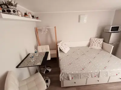 a small bedroom with a bed and a table at Au Coeur du Luberon in Cavaillon