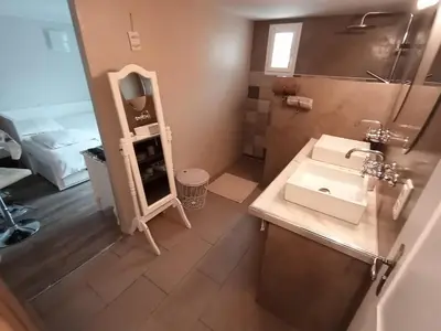 a small bathroom with a sink and a mirror at Au Coeur du Luberon in Cavaillon