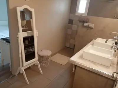 a bathroom with a sink and a mirror at Au Coeur du Luberon in Cavaillon