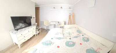 a childs bedroom with a bed with a crib and a tv at Au Coeur du Luberon in Cavaillon