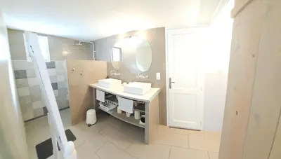 a bathroom with a sink and a mirror at Au Coeur du Luberon in Cavaillon