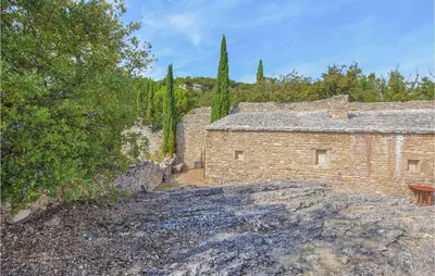 a brick building with trees in the background at Awesome Home In Bonnieux With Sauna in Bonnieux