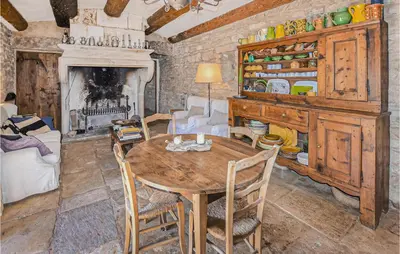 a dining room with a table and a fireplace at Awesome Home In Bonnieux With Sauna in Bonnieux