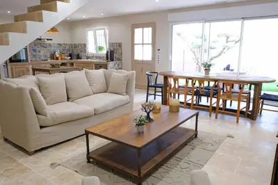 a living room with a couch and a table at charming house with private pool in the heart of the village of aureille in the alpilles, 6 people. in Aureille