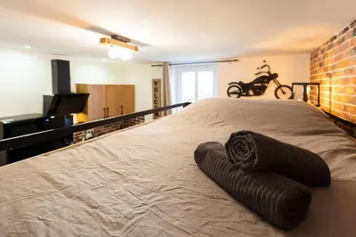a bedroom with a large bed with brown blankets on it at Bricks Industry Hyper Centre Fontaine Moussue in Salon-de-Provence