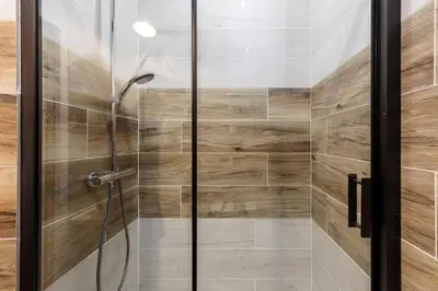 a shower with a glass door in a bathroom at Bricks Industry Hyper Centre Fontaine Moussue in Salon-de-Provence