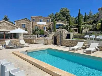 a villa with a swimming pool and a house at Villa Abayers in Apt
