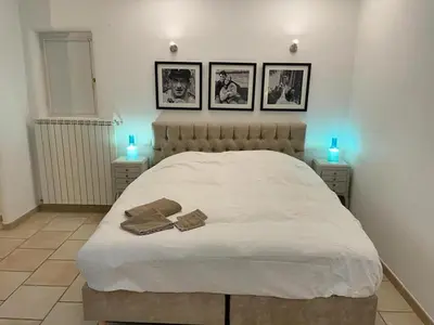 a bedroom with a white bed with two towels on it at Grands Abayers in Apt