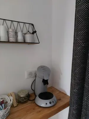 a kitchen counter with a coffee maker on a shelf at La Micocoule in La Barben