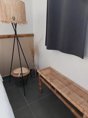 a room with a bench and a lamp and a table at La Micocoule in La Barben