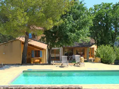 a house with a swimming pool in front of a house at Villa Bellegarde in Saignon