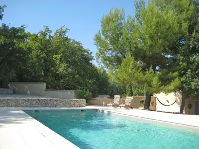a swimming pool in a yard with trees at Villa Bellegarde in Saignon