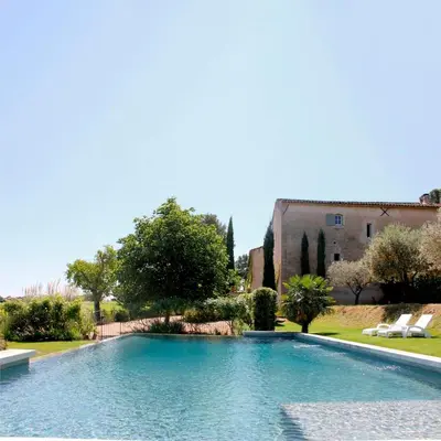 a large swimming pool in front of a house at Domaine Faverot in Maubec