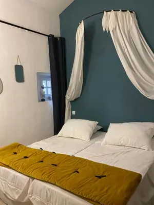 a bedroom with a bed with a canopy at Domaine Faverot in Maubec