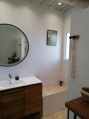 a bathroom with a sink and a tub and a mirror at Maison au calme entre vignes et Luberon in La Motte-dʼAigues