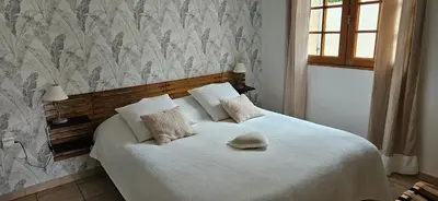 a bedroom with a white bed with a hat on it at Au pied du Massif des Costes in Pélissanne