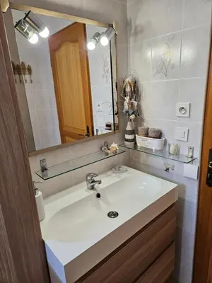 a bathroom with a white sink and a mirror at Au pied du Massif des Costes in Pélissanne