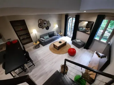 an overhead view of a living room with a couch and a table at Le Loft sur les quais in LʼIsle-sur-la-Sorgue