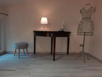 a table with a dress on a mannequin next to a lamp at Le Loft sur les quais in LʼIsle-sur-la-Sorgue