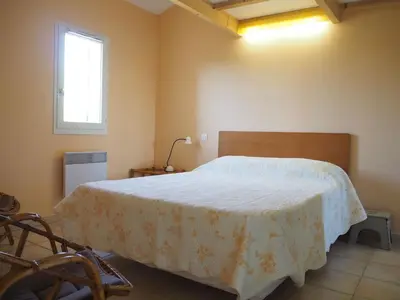 a bedroom with a bed with a white blanket on it at Cottage in Luberon near Apt Market in Apt