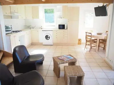 a kitchen and living room with a table and chairs at Cottage in Luberon near Apt Market in Apt