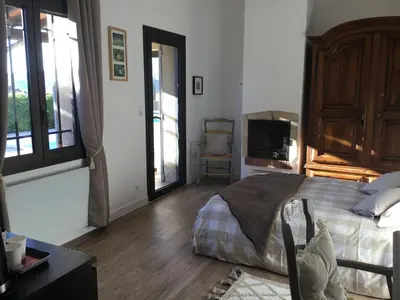 a bedroom with a bed and a tv in it at Petit cocon dans le Luberon in Lauris