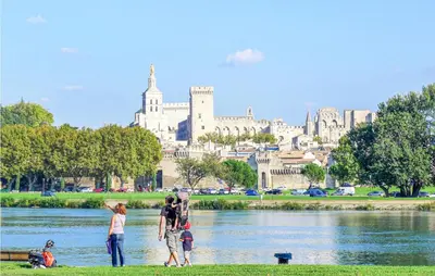 a group of people standing in the grass near a river at Cozy Home In Cabannes With Wifi in Cabannes