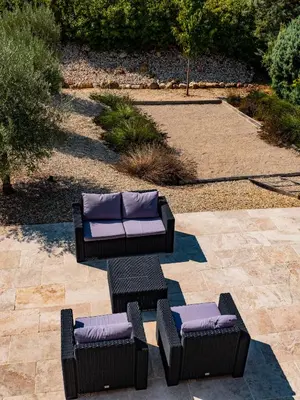 a patio with chairs and couches on a patio at Le Petit Rossignol in Apt
