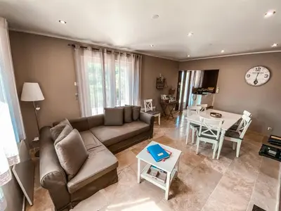 a living room with a couch and a table at Le Petit Rossignol in Apt