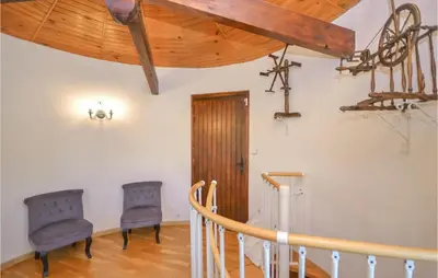 two blue chairs in a room with a wooden ceiling at Cozy Home In Aubignan in Aubignan