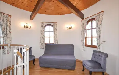 a living room with a blue ottoman and a chair at Cozy Home In Aubignan in Aubignan