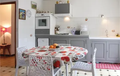 a kitchen with a table with fruit on it at 2 Bedroom Cozy Home In Saint Trinit in Sault-de-Vaucluse