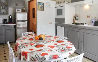 a kitchen with a table with fruit on it at 2 Bedroom Cozy Home In Saint Trinit in Sault-de-Vaucluse