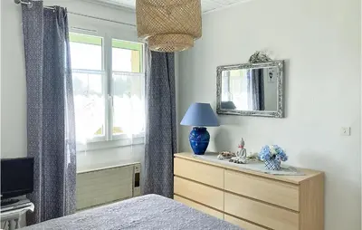 a bedroom with a bed and a dresser and a mirror at 2 Bedroom Cozy Home In Saint Trinit in Sault-de-Vaucluse