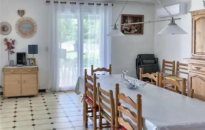 a kitchen and dining room with a table and chairs at 2 Bedroom Cozy Home In Saint Trinit in Sault-de-Vaucluse