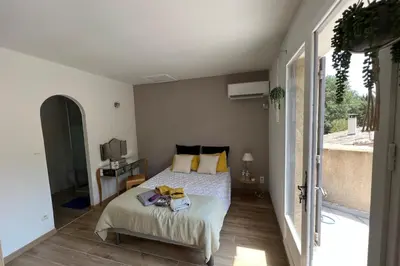 a bedroom with a bed with yellow pillows at Villa de 300 m au coeur du Luberon au calme sans in Maubec