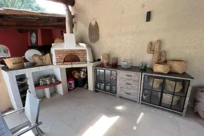 a room with a kitchen with a table and a stove at Villa de 300 m au coeur du Luberon au calme sans in Maubec