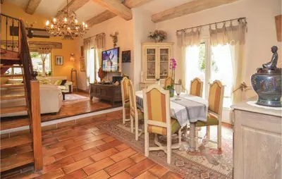 a kitchen and dining room with a table and chairs at Amazing Home In Orgon in Orgon
