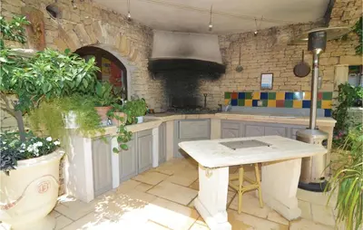 a kitchen with a table and some plants at Amazing Home In Orgon in Orgon