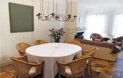 a dining room with a white table and chairs at Nice Home In St Didier With Kitchen in Saint-Didier