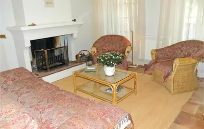 a living room with a couch and a table with flowers at Nice Home In St Didier With Kitchen in Saint-Didier