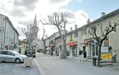 a city street with cars parked on the street at Nice Home In St Didier With Kitchen in Saint-Didier