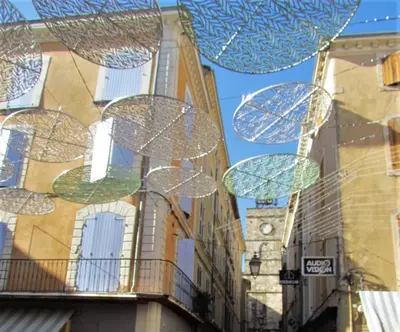a group of umbrellas hanging from the side of a building at nid2nuit Nuance d'Ocres in Apt