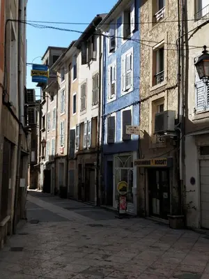 an empty alley with blue and white buildings at AptCityStay in Apt