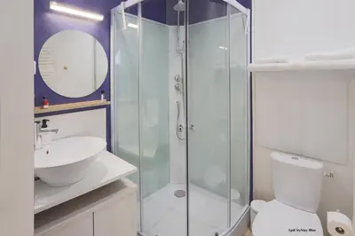 a bathroom with a shower and a toilet and a sink at AptCityStay in Apt