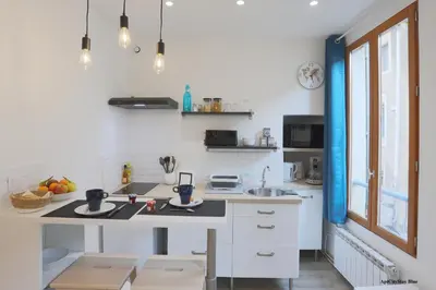 a kitchen with white cabinets and a counter top at AptCityStay in Apt