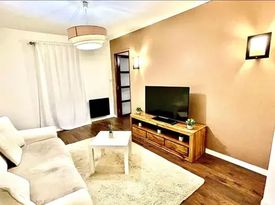 a living room with a couch and a flat screen tv at *FONTAINE MOUSSUE*HYPER CENTRE*T2 STANDING* in Salon-de-Provence