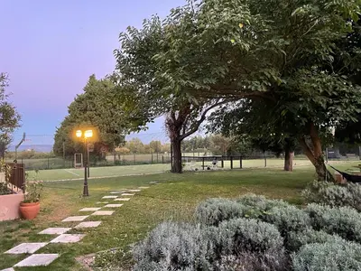 a park with a street light and trees and plants at Mas de la Sacristière in Jonquerettes
