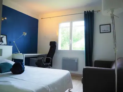 a bedroom with a bed and a desk and a window at Holiday Home in Pertuis with Private Pool in Pertuis