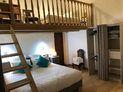 a bedroom with a bunk bed and a staircase at Villa du defens in Saint-Martin-de-Castillon